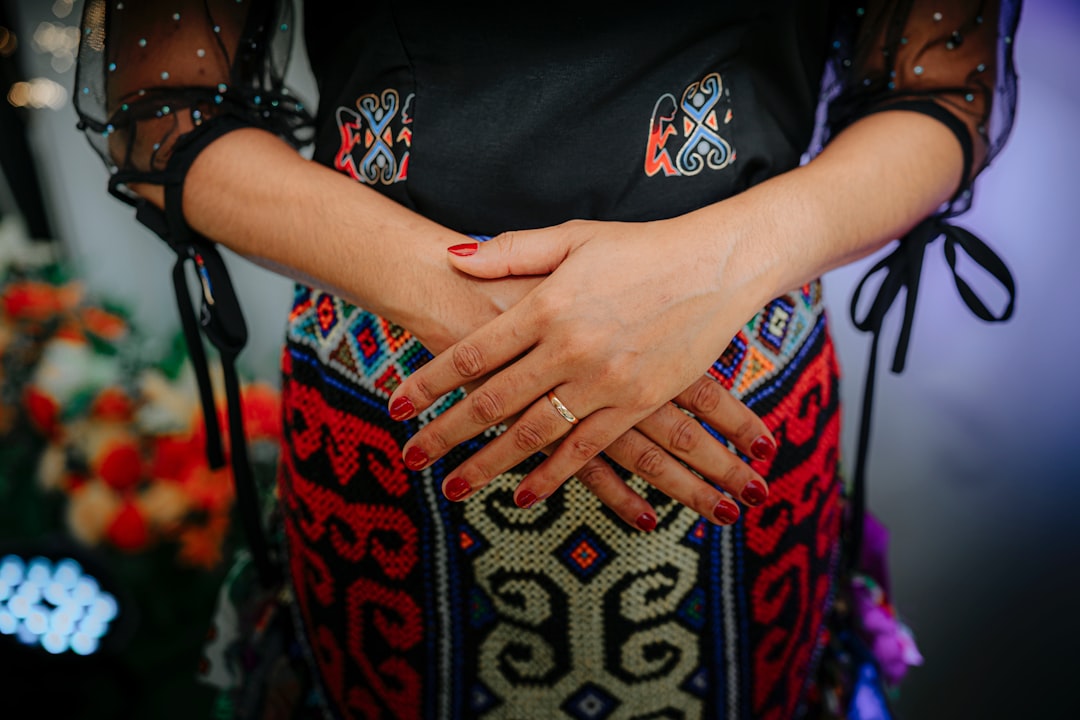 Woman wearing a dress with crossed hands.
