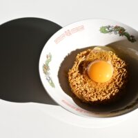 An egg in a bowl on a table