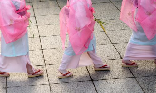 A group of young girls walking down a sidewalk
