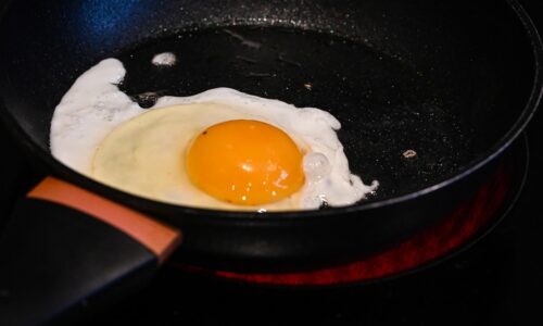 A fried egg in a frying pan on a stove