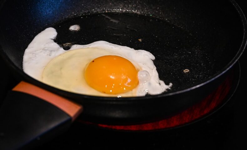 A fried egg in a frying pan on a stove