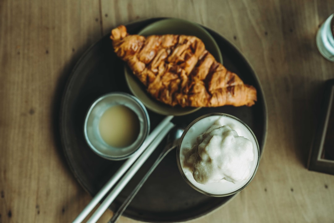 A wooden table topped with a plate of food