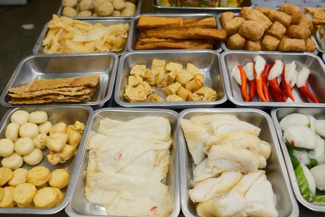 A table topped with trays of different types of food